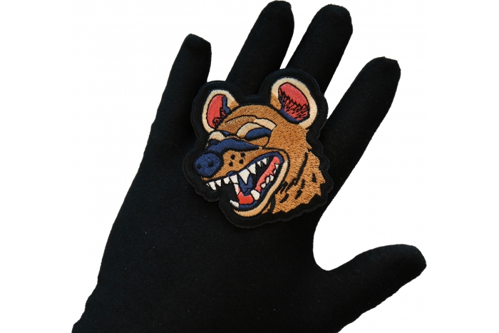 Laughing Hyena Iron on Patch shown on hand for size comparison