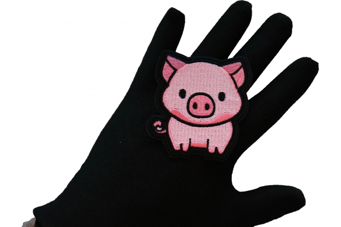 Little Piggy Iron on Patch shown on hand for size comparison