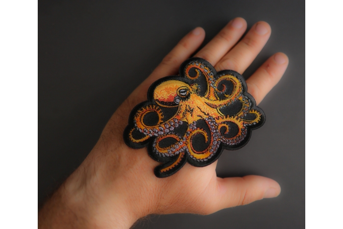 Octopus Patch shown on hand for size comparison
