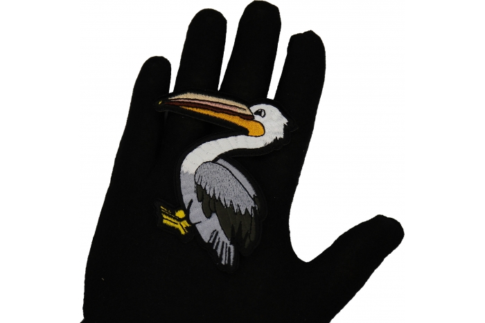 Pelican Patch shown on hand for size comparison