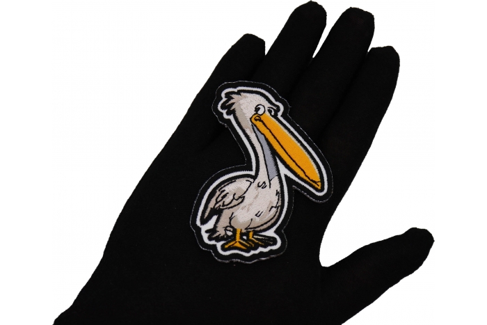 Pelican Patch shown on hand for size comparison