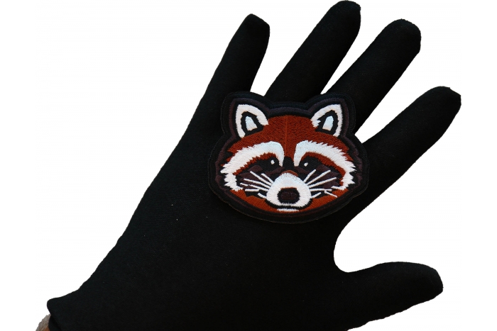 Raccoon Iron on Patch shown on hand for size comparison