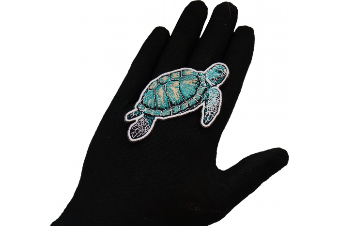 Sea Turtle Patch shown on hand for size comparison