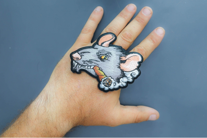 Smoking Rat Patch shown on hand for size comparison