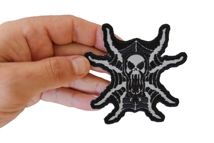 Spider Skull Reflective Iron on Patch shown on hand for size comparison