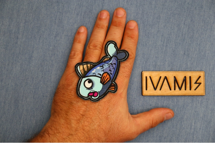 Surprised Fish Patch shown on hand for size comparison