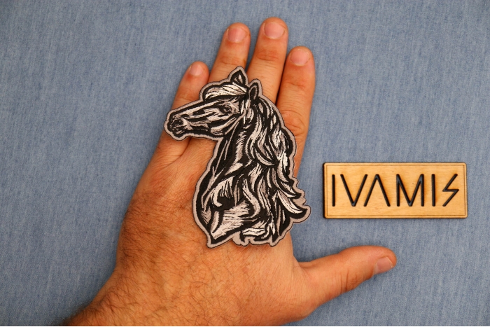 Tribal Horse Patch shown on hand for size comparison