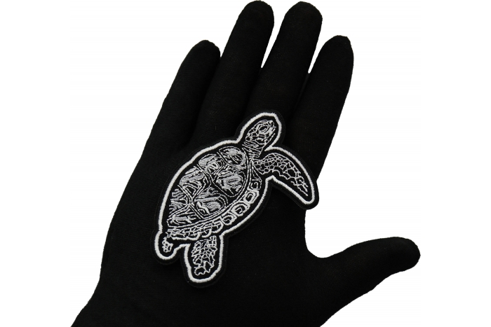 Tribal Turtle Patch shown on hand for size comparison