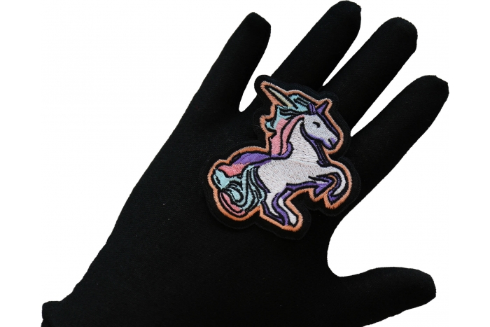 Unicorn Iron on Patch shown on hand for size comparison