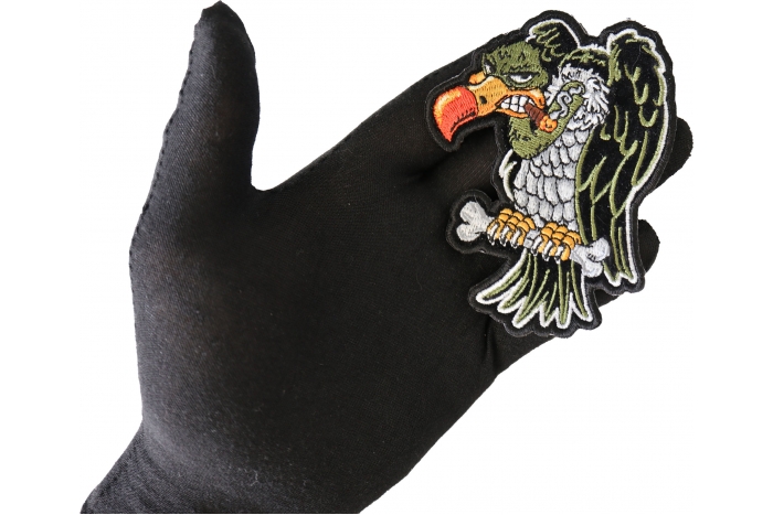 Vulture Sew on Patch for Vests shown on hand for size comparison