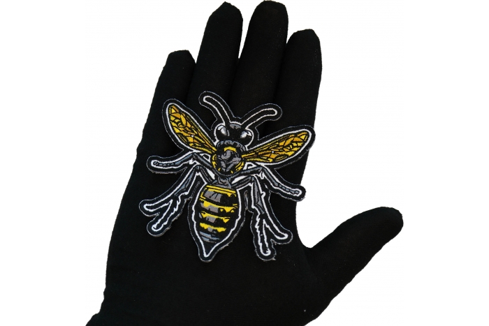 Wasp Patch shown on hand for size comparison