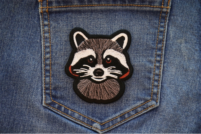 Cheeky Raccoon Iron on Patch shown on jeans