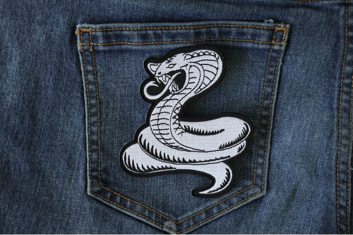 Cobra White Patch shown on jeans