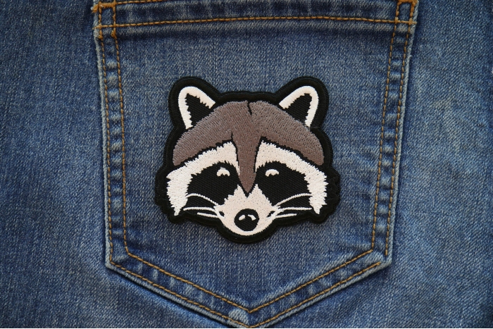 Funny Raccoon Iron on Patch shown on jeans