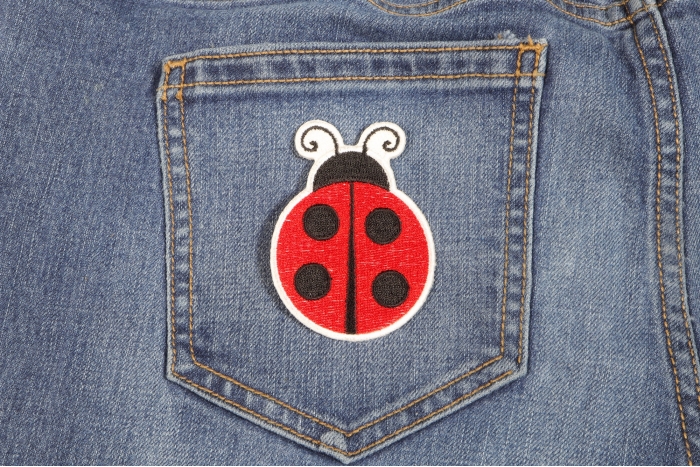 Lady Bug Iron On Patch shown on jeans