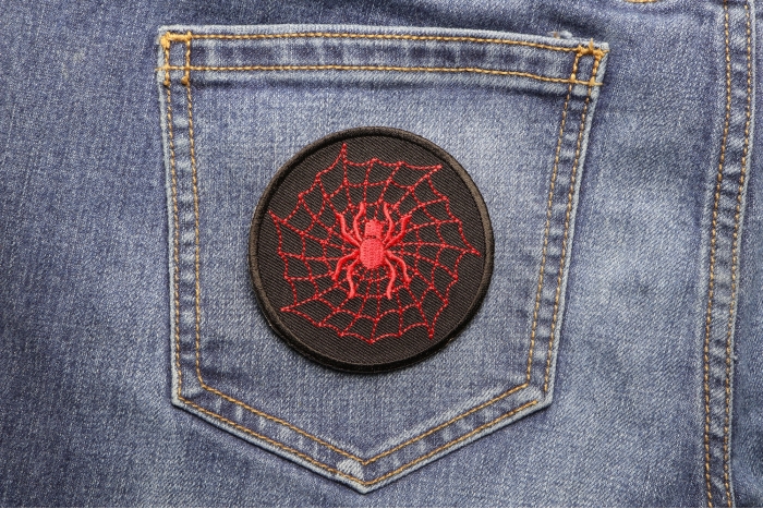 Red Spider and Web Iron on Patch shown on jeans