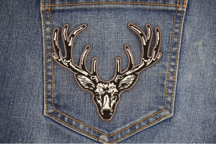 White Deer Head Patch shown on jeans