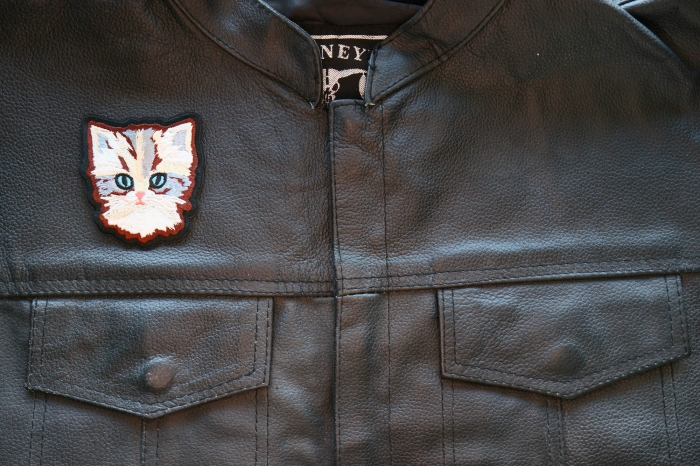 Adorable Cat Iron on Patch shown on leather vest