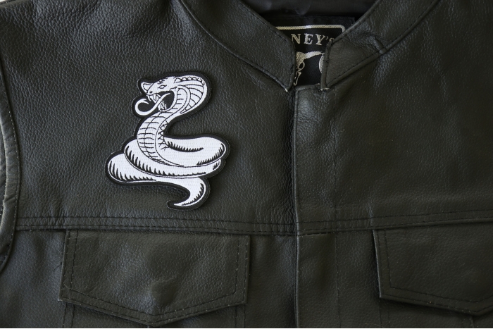 Cobra White Patch - 3.5x4 inch. Embroidered Iron on Patch shown on leather vest
