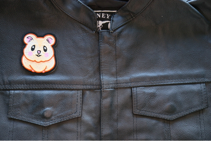 Cute Hamster Iron on Patch shown on leather vest