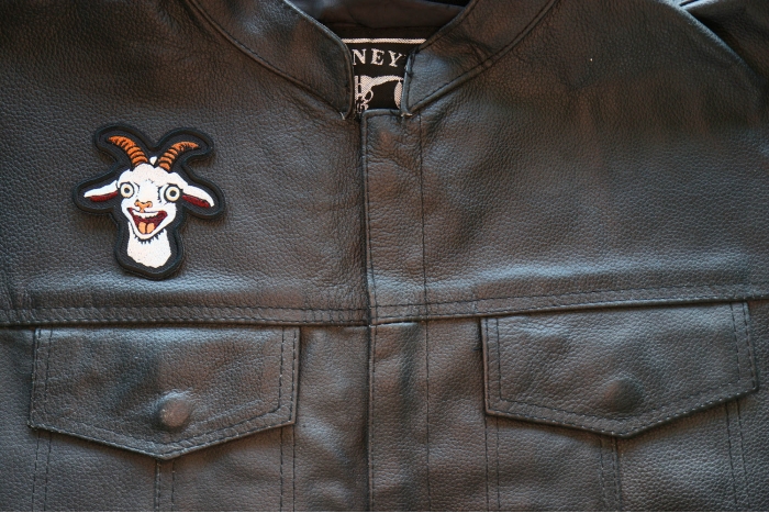 Hello Goat Iron on Patch shown on leather vest