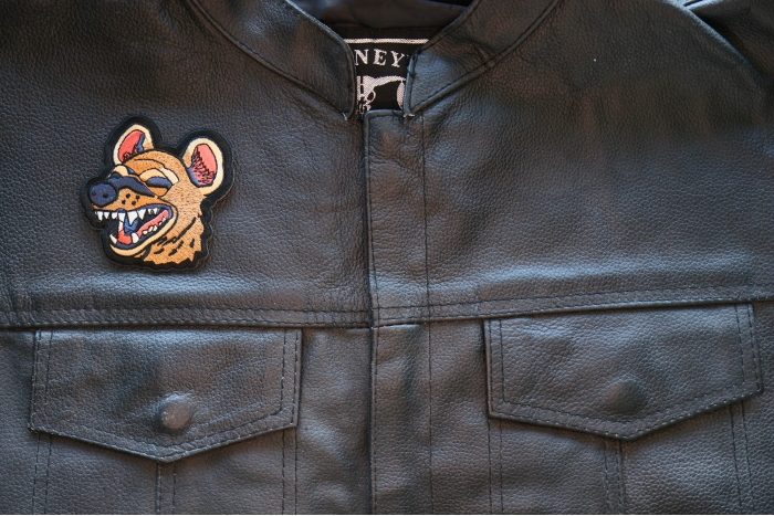 Laughing Hyena Iron on Patch shown on leather vest