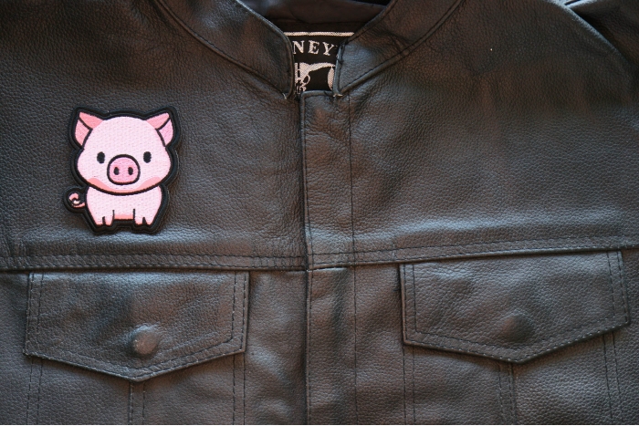 Little Piggy Iron on Patch shown on leather vest