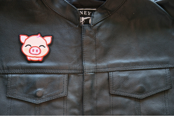 Piglet Iron on Patch shown on leather vest