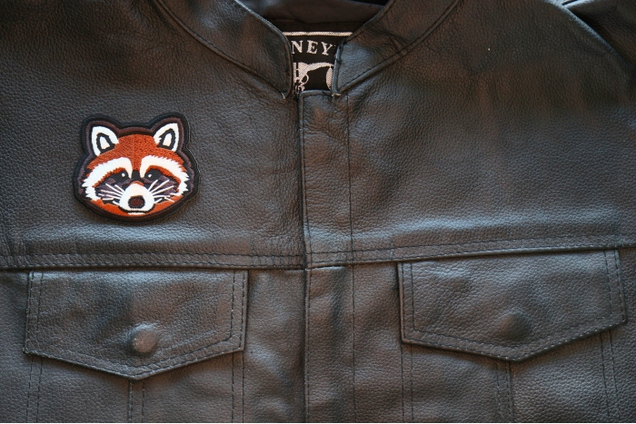 Raccoon Iron on Patch shown on leather vest