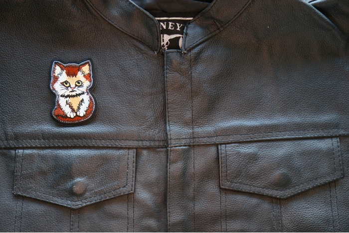 Sad Kitty Cat Iron on Patch shown on leather vest