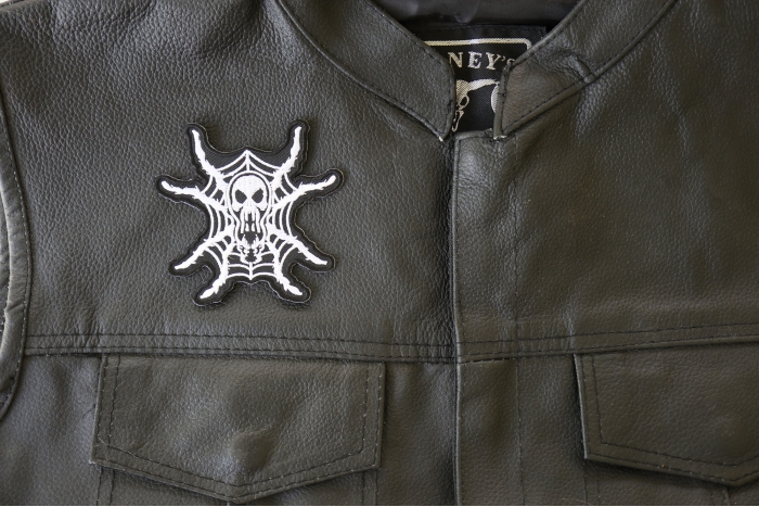 Spider Skull Patch - 3.5x3.4 inch. Embroidered Iron on Patch shown on leather vest