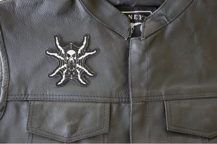 Spider Skull Reflective Patch - 3.5x3.4 inch. Embroidered Iron on Patch shown on leather vest
