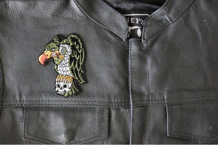 Vulture On Skull Patch - 3x4 inch - Embroidered Iron on Patch shown on leather vest