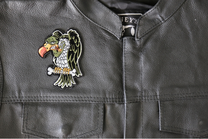 Vulture Patch Smoking a Cigar - 3x4 inch - Embroidered Iron on Patch shown on leather vest