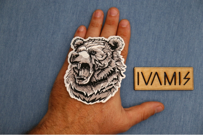 Angry Bear Patch shown on hand for size comparison