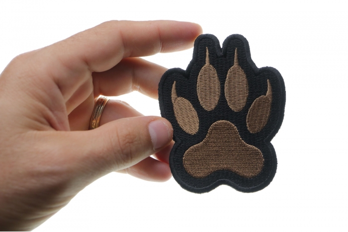 Canine Paw Print Iron on Patch shown on hand for size comparison