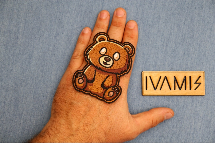 Brown Bear Patch shown on hand for size comparison