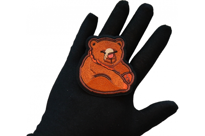 Funny Bear Iron on Patch shown on hand for size comparison