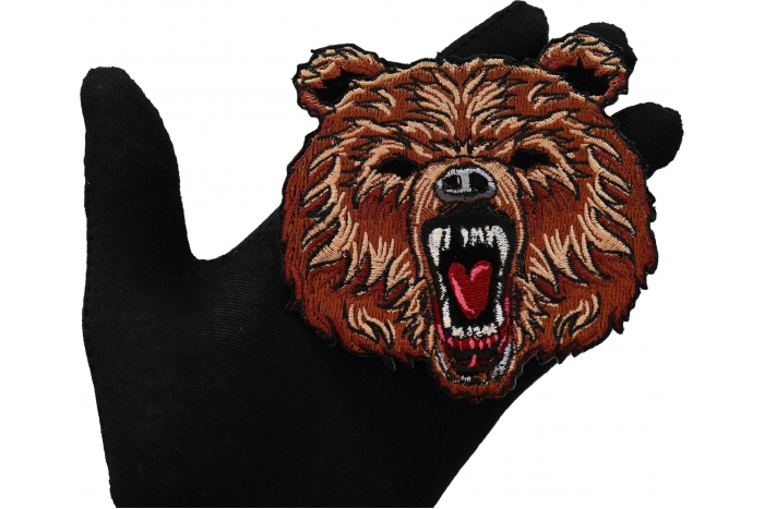 Furry Bear Patch shown on hand for size comparison