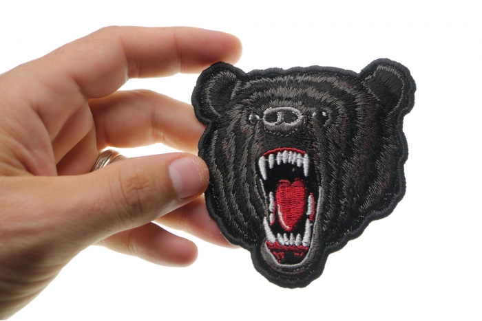 Small Black Bear Biker Iron on Patch shown on hand for size comparison