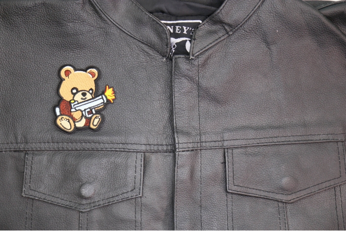 Cute Bear Machine Gun Patch shown on leather vest