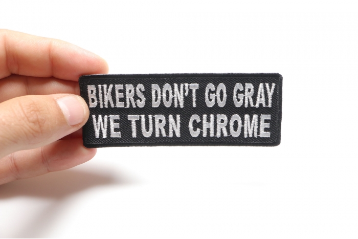 Bikers Don't Go Gray We Turn Chrome Patch, Biker Saying Patches shown on hand for size comparison
