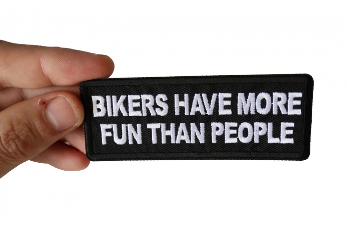 Bikers have more Fun than People Patch, Biker Saying Patches shown on hand for size comparison
