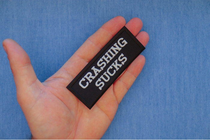 Crashing Sucks Patch, Biker Saying Patches shown on hand for size comparison