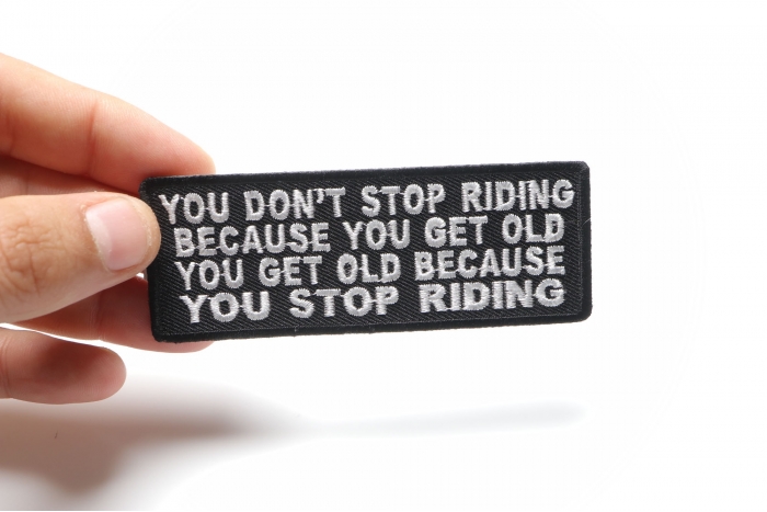 You Don't Stop Riding Because You Get Old, You Get Old Because You Stop Riding Patch, Biker Saying Patches shown on hand for size comparison