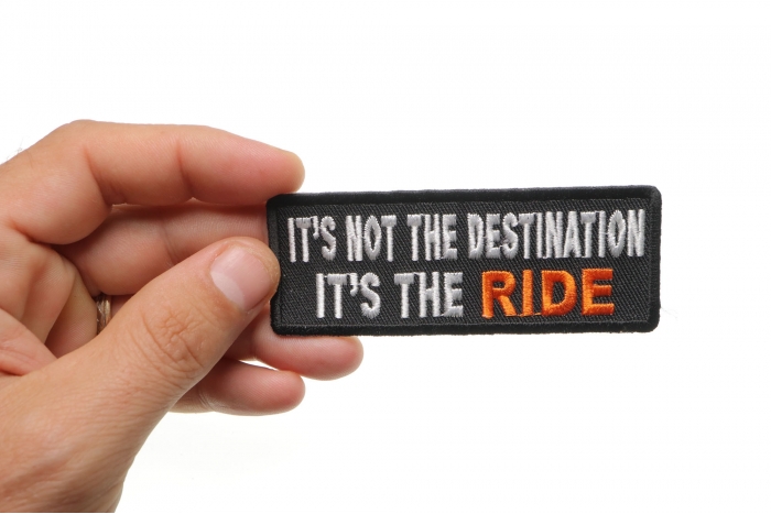 It's Not The Destination It's The Ride Patch, Biker Saying Patches shown on hand for size comparison