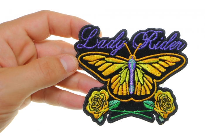 Lady Rider Butterfly With Yellow Roses Small Iron on Biker Patch shown on hand for size comparison