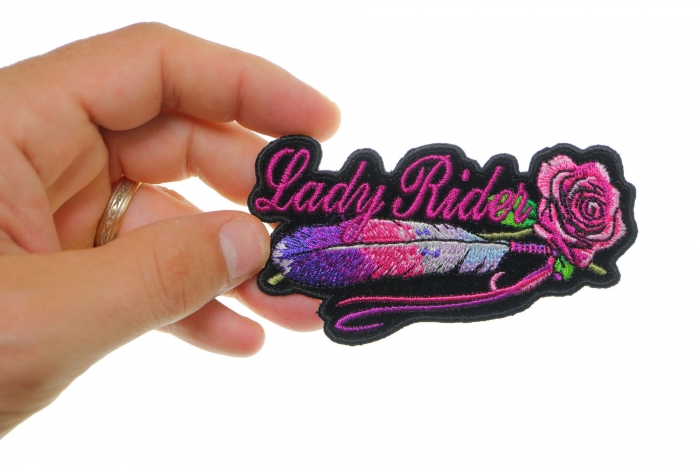 Lady Rider Pink Rose and Feathers Small Iron on Biker Patch shown on hand for size comparison