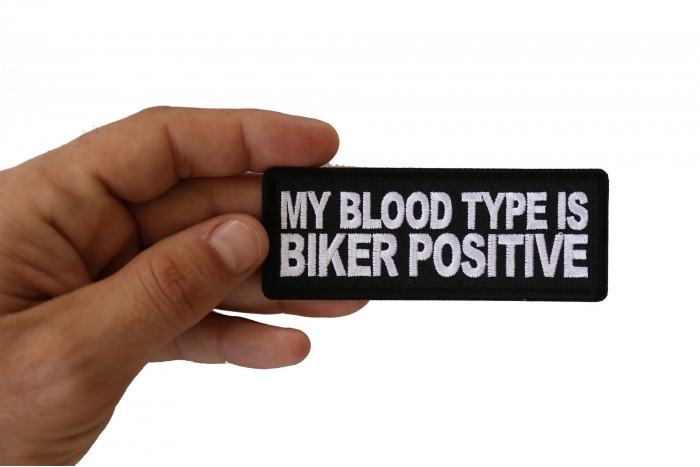 My Blood Type is Biker Positive Patch, Biker Saying Patches shown on hand for size comparison