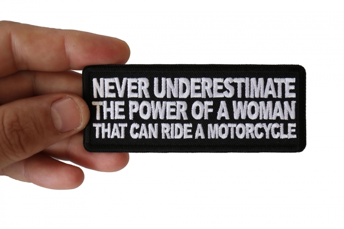 Never Underestimate the Power of a Woman That Can Ride a Motorcycle Patch, Biker Saying Patches shown on hand for size comparison